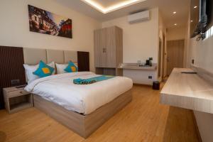 a bedroom with a large bed and a kitchen at Hotel Crown Plaza in Kathmandu