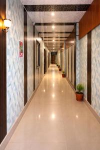 an empty hallway in a building with potted plants at Hotel Sunrahi in Nagīna