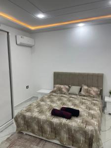 a bedroom with a large bed in a white room at Villa Assef in Midoun