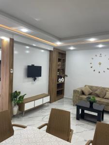 a living room with a couch and a tv at Villa Assef in Midoun