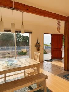 a dining room with a table and a view of the ocean at Linga Longa in Britannia Bay