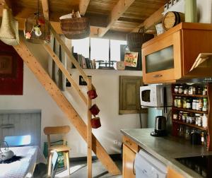 a kitchen with a spiral staircase in a room at Les capucins de Provins Maison in Provins