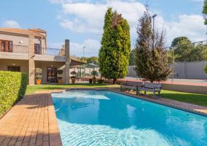 a swimming pool in the backyard of a house at Via Positano 95, Paulshof in Sandton