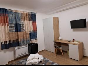 a room with a desk and a tv and a desk and a deskictericter at Da Tea in Olzai +32 photos
