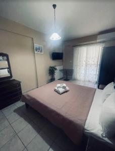 a bedroom with a bed with a towel on it at Klapidis apartments in Kriopigi