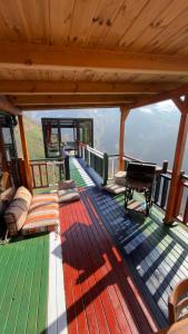 a deck with a couch and a bench on a house at Northland Bungalows in Çayırdüzü