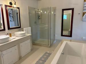 a bathroom with a tub and two sinks and a shower at The Suite in Stanford