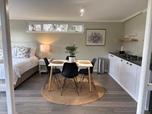 a small kitchen with a table and chairs in a room at The Suite in Stanford +7 photos