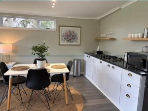 a kitchen with a table and chairs and a counter top at The Suite in Stanford