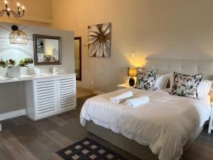 a bedroom with a bed with a mirror and a sink at The Suite in Stanford