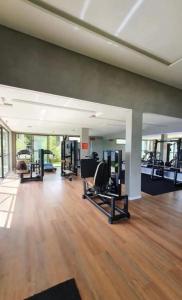 a gym with several treadmills and machines in a room at Apartamento completo, moderno e bem localizado in Parnamirim