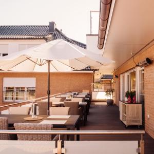 a restaurant with tables and chairs and umbrellas at Beauty Concept SPA in Lübeck