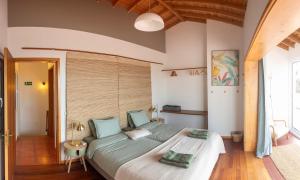 a bedroom with a large bed in a room at Casa Silke in Vila Franca do Campo