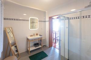 a bathroom with a sink and a shower at Casa Silke in Vila Franca do Campo +100 photos