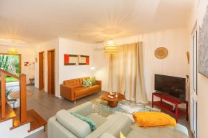 a living room with a couch and a tv at Casa Silke in Vila Franca do Campo