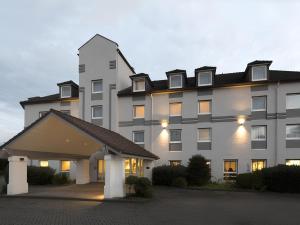 a large white building with a lot of windows at ibis Styles Cologne Airport in Troisdorf