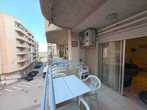 a balcony with a table and chairs on a building at Santa Pola port in Santa Pola