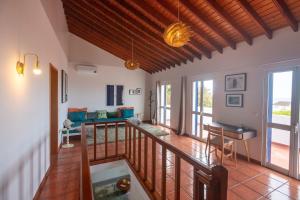 a room with a balcony with a living room at Casa Silke in Vila Franca do Campo