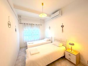 a bedroom with two beds and a window at Santa Pola port in Santa Pola