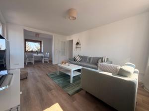 a living room with a couch and a table at Cozy Home in Schramberg +25 photos
