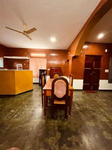 a dining room with a table and chairs at Gravity Groups Blue Lagoon Villa in Kuilapayam +8 photos