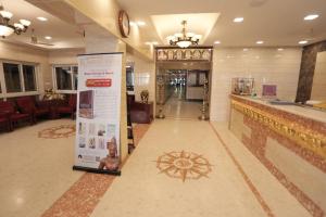 a lobby with a bar with a sign in the middle at Hotel Rayas in Kumbakonam