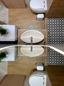 a bathroom with two toilets and a sink at 48 Downtown Lofts in Nea Peramos +45 photos