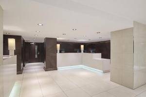 a large room with white walls and a tile floor at DoubleTree by Hilton London - Hyde Park in London