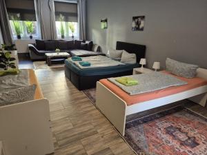 a living room with two beds and a couch at Flensburg City - 24h in Flensburg +101 photos