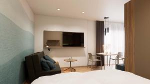 a bedroom with a bed and a table and a chair at Harabruck Apartments in Gmünd