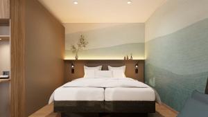 a bedroom with a large bed with white sheets at Harabruck Apartments in Gmünd