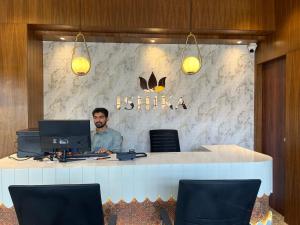 a man sitting at a desk with a computer at ishika grand in Secunderabad