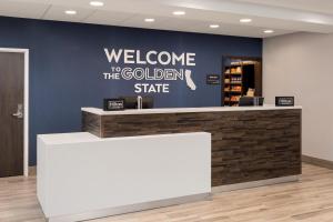 a welcome to the golden state sign on a blue wall at Hampton Inn & Suites Manteca in Manteca +88 photos