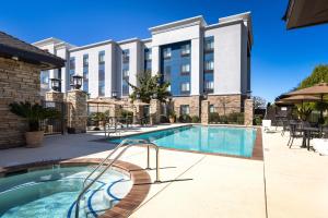 a swimming pool in front of a building at Hampton Inn & Suites Manteca in Manteca