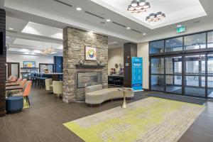 a lobby with a fireplace and a waiting room at Hampton Inn by Hilton Winnipeg in Winnipeg
