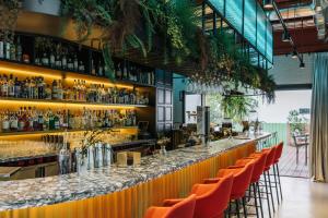 a bar in a restaurant with orange chairs at The Social Hub Madrid in Madrid