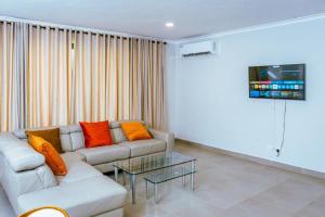 a living room with a couch and a table at 219 Contours Luxury Apartment in Victoria Falls