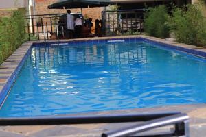 a swimming pool with blue water in a yard at Azure View Studio with pool in Kiahuria
