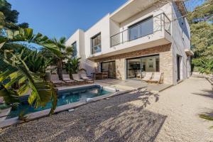 a house with a swimming pool in front of it at Enjoy 5Bdr villa pool and BBQ in Saint-Raphaël