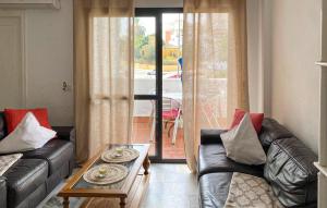 a living room with two leather couches and a coffee table at 2 Bedroom Lovely Apartment In Estepona in Estepona