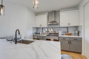 a kitchen with white cabinets and stainless steel appliances at Chic Austin House w/ Spacious Backyard & Hammock in Austin