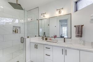 a white bathroom with a sink and a mirror at Chic Austin House w/ Spacious Backyard & Hammock in Austin +24 photos
