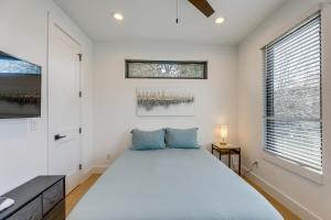 a bedroom with a large bed and a window at Chic Austin House w/ Spacious Backyard & Hammock in Austin