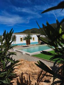 a swimming pool in front of a white building at Can Pep Pardal in Sant Miquel de Balansat