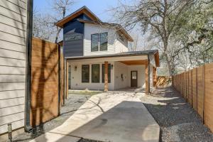 a white house with a blue roof at Chic Austin House w/ Spacious Backyard & Hammock in Austin