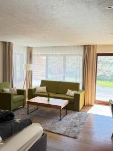 a living room with a couch and a coffee table at Landhaus Langeck in Münstertal +98 photos