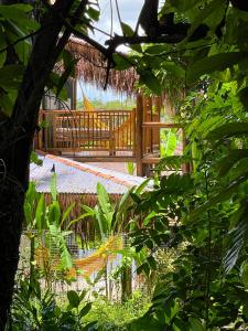a wooden walkway with a deck in the distance at Casa Felina in Ilha de Boipeba