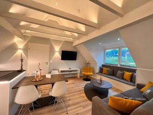a living room with a couch and a table at Hotel LandGut & Residenz DRIEHOF in Tecklenburg