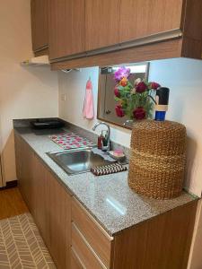 a kitchen with a sink and a counter top at Super Cozy Condo Davao in Davao City