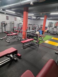 a gym with lots of red chairs and machines at Center- Podčetrtek in Podčetrtek +5 photos